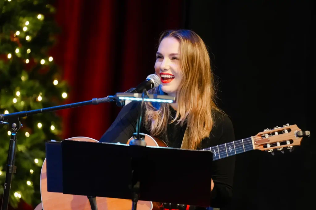 Abbi Berry smiling with guitar