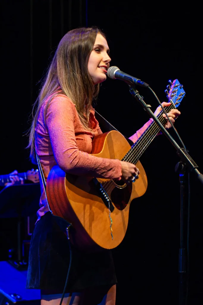 Abbi Berry singing and playing guiter